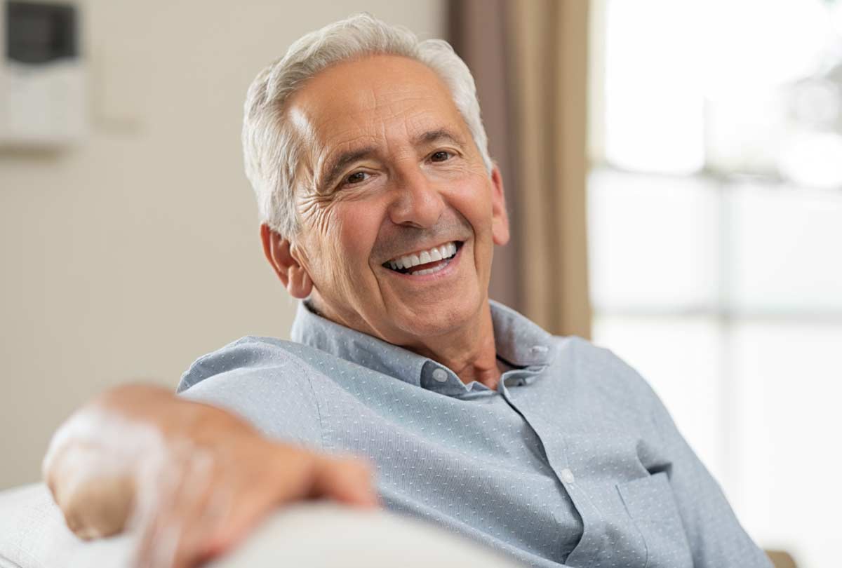 oxyfresh pro relief dental gel image of a smiling older gentleman sitting on a couch