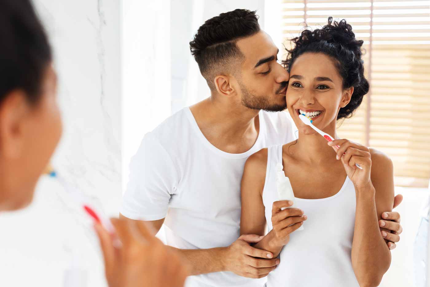 Couple-smiling-sharing-a-loving-moment-while getting ready for the day