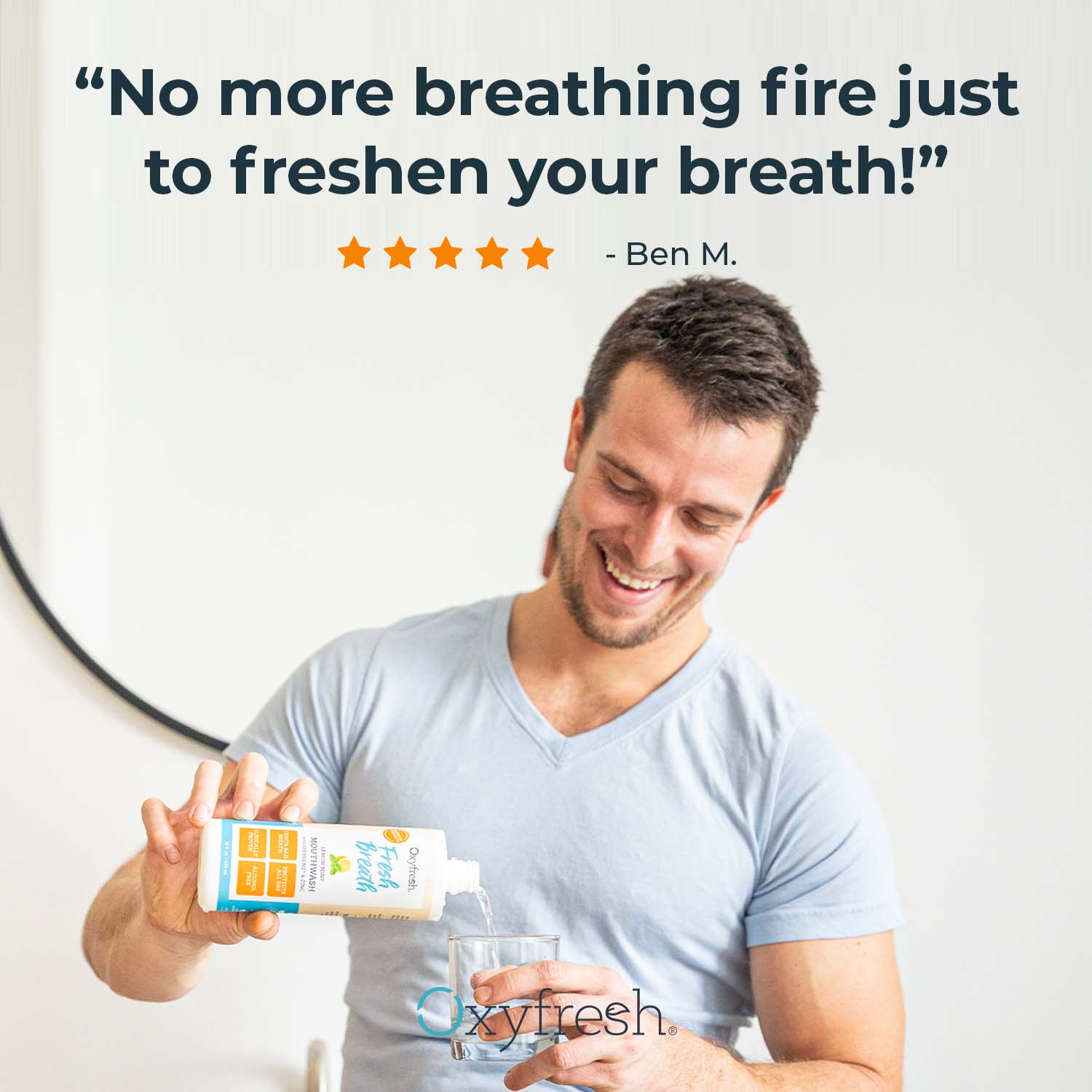 oxyfresh lemon mint mouthwash man pouring into mouthrinse glass with review that says no more breathing fire just to freshen your breath